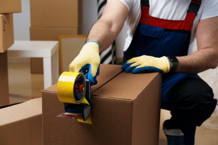 Worker wrapping a box